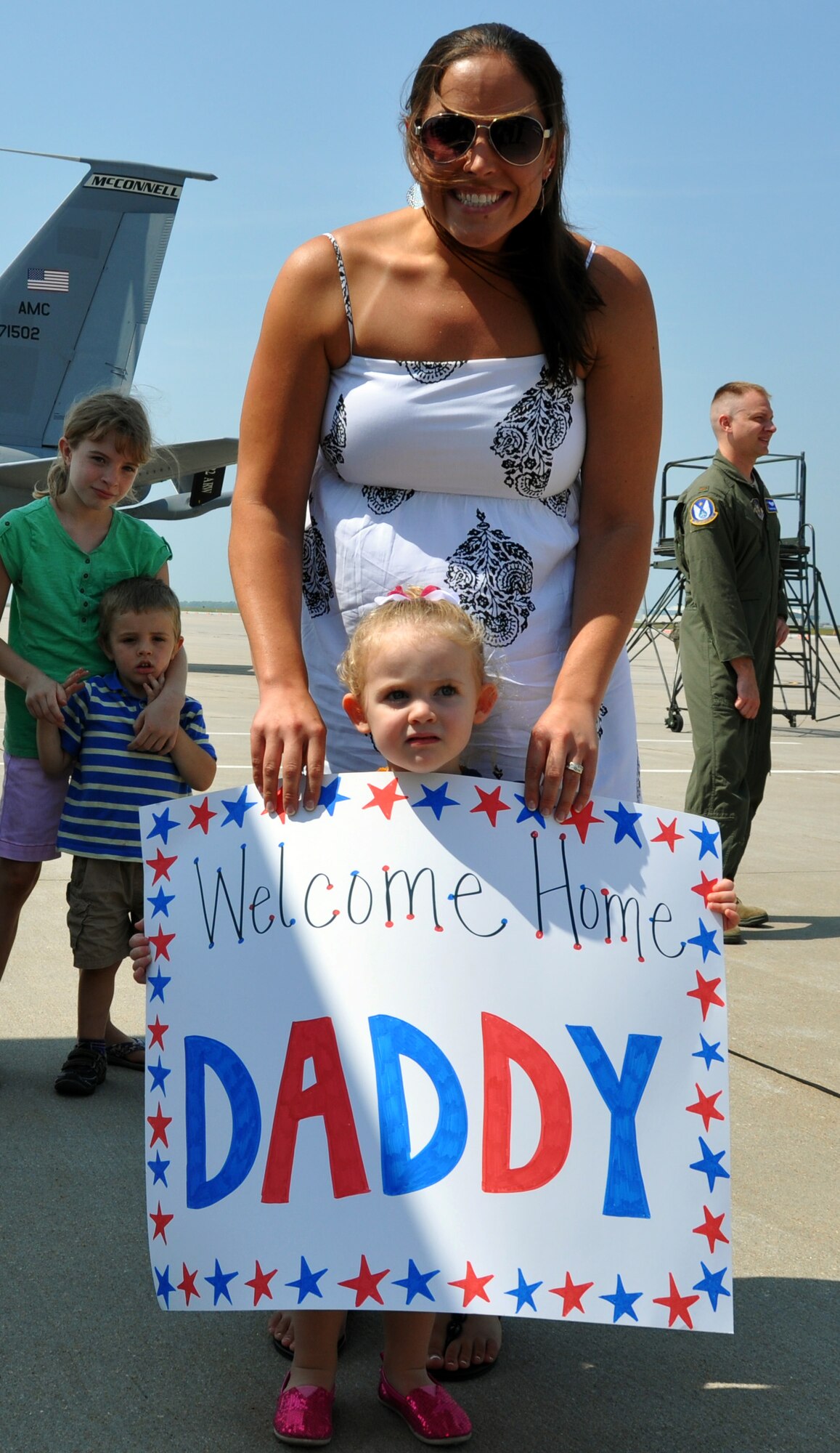 Family members of 931st Air Refueling Group Airmen wait on the flightline to welcome their deployed Airmen home at McConnell Air Force Base, Kan., July 21, 2014.  Several Reservists from the 931 ARG returned home from a 60-day deployment to  deployment to Al Udeid Air Base, Qatar, where they served as part of the 379th Air Expeditionary Wing.  (U.S. Air Force photo by Capt. Zach Anderson)   