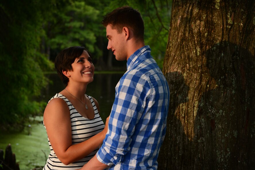 U.S. Air Force Airmen 1st Class, Michael and Diana Cossaboom, 20th Fighter Wing Public Affairs photojournalists, pose for a photo at Swan Lake and Iris Gardens near Shaw Air Force Base, S.C., July 19, 2014. The Cossabooms participated in a six week marriage mentorship program created by Chaplain (Maj.) Richard Holmes, 20th FW interim deputy wing chaplain, which helped the two better their communication skills. (U.S. Air Force photo by Airman 1st Class Jensen Stidham/Released)