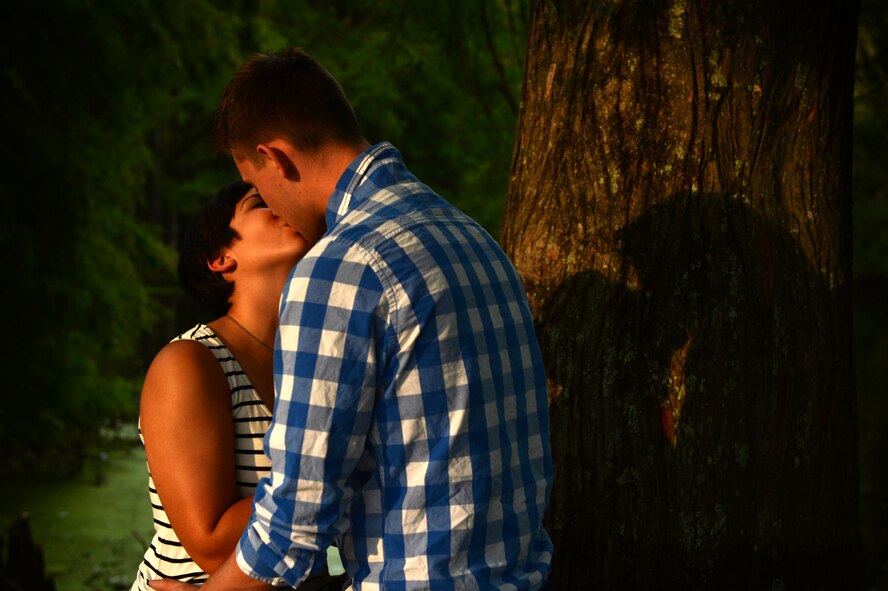 U.S. Air Force Airmen 1st Class, Michael and Diana Cossaboom, 20th Fighter Wing Public Affairs photojournalists, pose for a photo at Swan Lake and Iris Gardens near Shaw Air Force Base, S.C., July 19, 2014. The Cossabooms participated in a six week marriage mentorship program created by Chaplain (Maj.) Richard Holmes, 20th FW interim deputy wing chaplain, which helped the two better their communication skills. (U.S. Air Force photo by Airman 1st Class Jensen Stidham/Released)