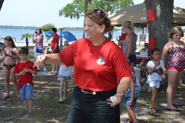 Col. (Ret.) Sheree Etter, wife of Lt. Gen. William Etter, Continental U.S. North American Aerospace Defense Region – 1st Air Force (Air Forces Northern) Commander, reacts to a broken egg as she participates in an egg toss contest during AFNORTH Family Day June 27 at Bonita Bay. (Photo by Mary McHale) 

