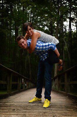 U.S. Air Force Airmen 1st Class, Michael and Diana Cossaboom, 20th Fighter Wing Public Affairs photojournalists, pose for a photo at Swan Lake and Iris Gardens near Shaw Air Force Base, S.C., July 19, 2014. The Cossabooms participated in a six week marriage mentorship program created by Chaplain (Maj.) Richard Holmes, 20th FW interim deputy wing chaplain, which helped the two better their communication skills. (U.S. Air Force photo by Airman 1st Class Jensen Stidham/Released)