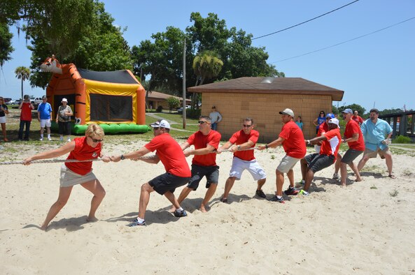 Maj. Katrina Andrews, (left) Chief of Air Forces Northern Protocol Office, leads a tug-of-war team from the command element and personal staff during AFNORTH Family Day June 27 at Bonita Bay. (Photo by Mary McHale) 

