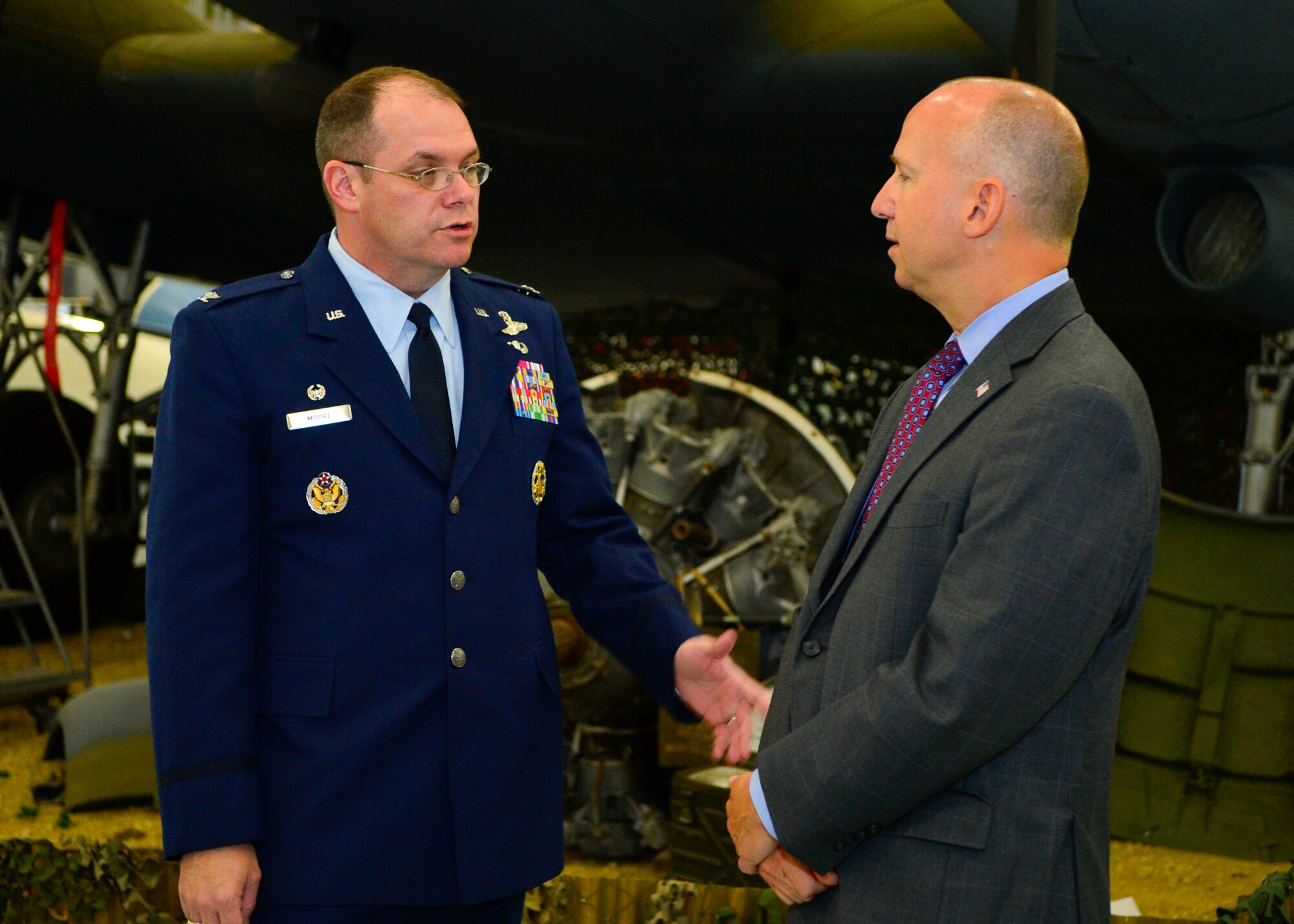 Col. Rick Moore, 436th Airlift Wing commander, speaks with Delaware Governor Jack Markell, at a bill signing event July 21, 2014, at the Air Mobility Command Museum on Dover Air Force Base, Del. Markell used the AMC Museum as a forum for the signing event.  (U.S. Air Force photo/Airman 1st Class Zachary Cacicia)