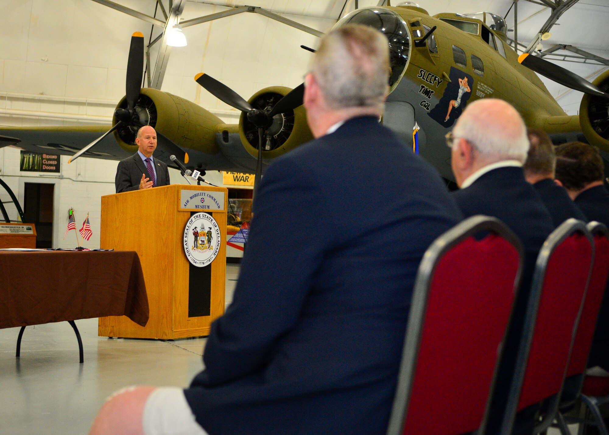 Delaware Governor Jack Markell speaks to a crowd of Team Dover personnel, Delaware veterans and Delaware State officials who are attending a bill signing ceremony July 21, 2014, at the Air Mobility Command Museum on Dover Air Force Base, Del. Markell signed two bills at the event, HB 296 and HB 324, that make it easier for military veterans to transition from active duty to civilian life. (U.S. Air Force photo/Airman 1st Class Zachary Cacicia)