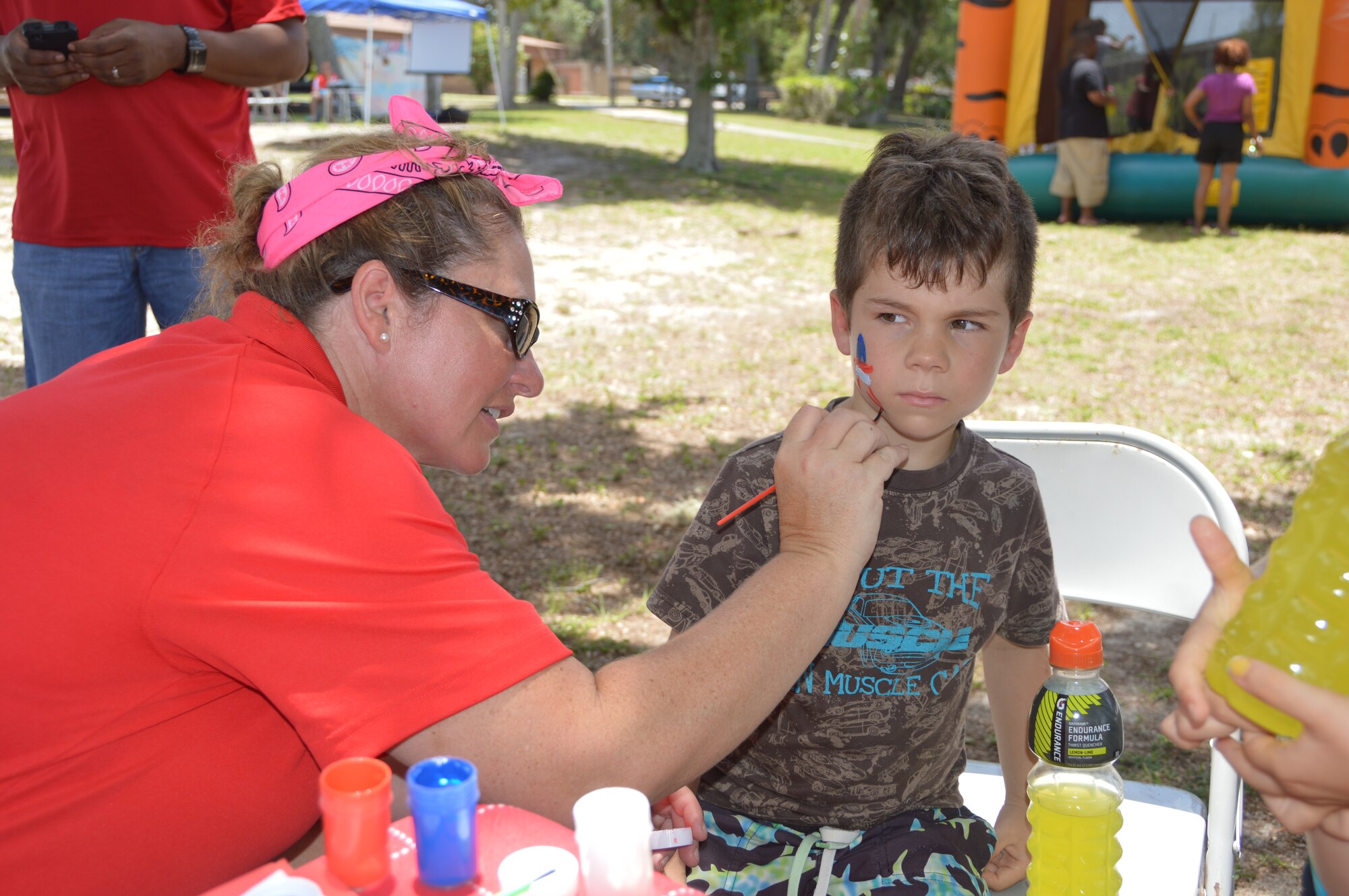 Senior Master Sgt. Lorene Kitzmiller, Air Forces Northern First Sergeant, paints the face of a young visitor during AFNORTH’s Family Day June 27 at Bonita Bay. It was a day filled with food and a variety of activities. (Photo by Mary McHale)