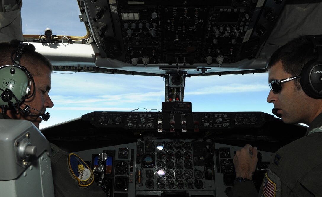 Lt. Col. Kirk Chestnut instructs Capt. John Meixell, a recent graduate of pilot training, during a KC-135 Stratotanker training flight over Virginia July 18, 2014. Meixell and Chestnut are 756th Airlift Squadron pilots. This was Meixell’s first flight since graduating technical training. (U.S. Air Force photo/ Senior Airman Nesha Humes)                                                    