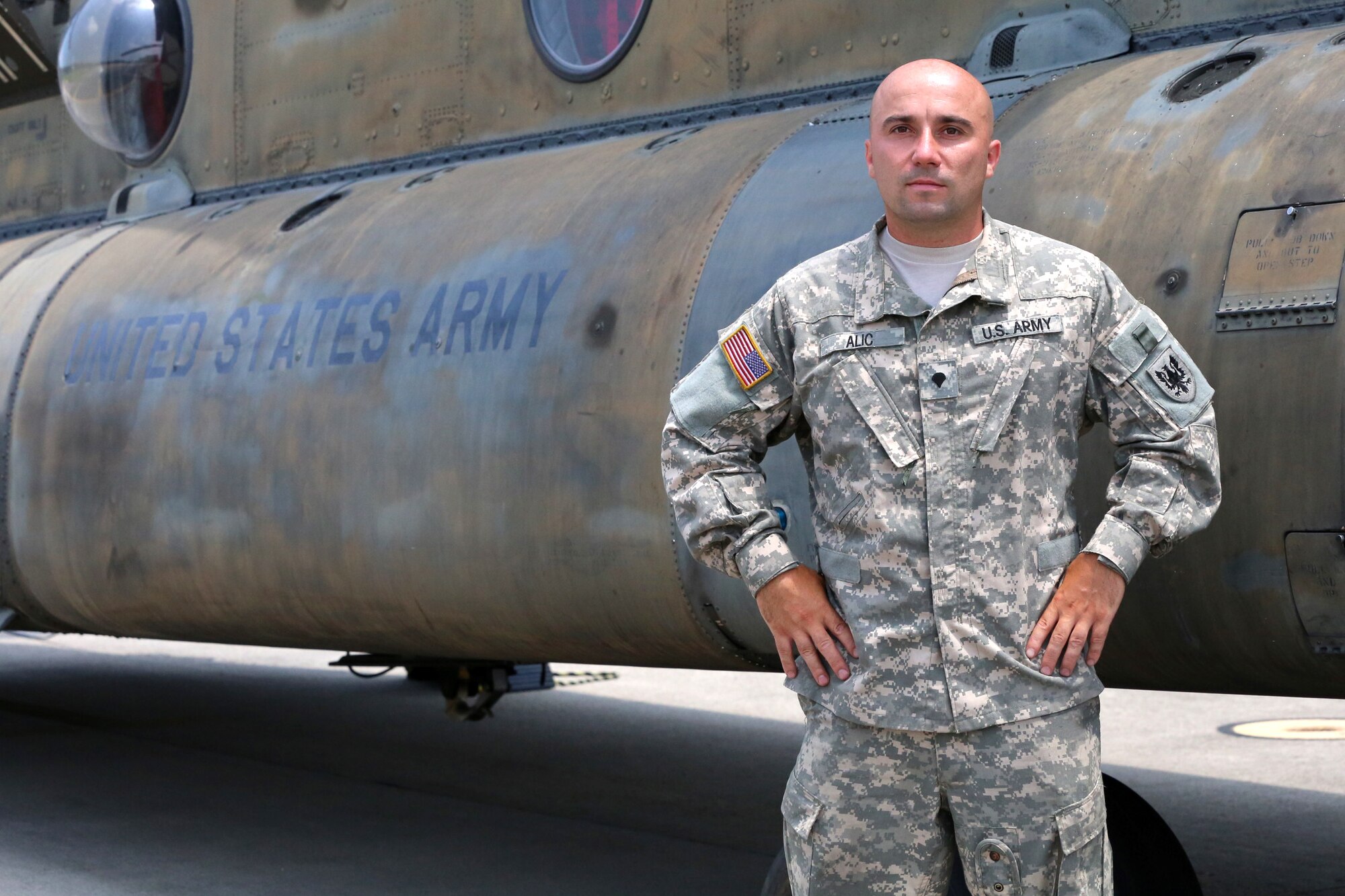U.S. Army Spc. Sasha Alic, crew chief, Bravo Company, 5-159th General Support Aviation Battalion, 244th Aviation Brigade pauses as he prepares  for takeoff for a vision recognition training flight out Felker Army Airfield on Fort Eustis, Va., July 8, 2014. A vision recognition training flight is a flight where the pilot uses landmarks, roads and waterways to navigate the helicopter.  The 5-159th GSAB is a part of Task Force Aviation, a component of Joint Task Force Civil Support. Task Force Aviation is the only aviation brigade in the Army Reserves. Their mission is to provide command and control of aviation assets to support JTF-CS. JTF-CS anticipates, plans and prepares for chemical, biological, radiological and nuclear defense support to civil authorities response operations. (DOD photo by U.S. Marine Corps Gunnery Sgt. Helen Searcy/Released)