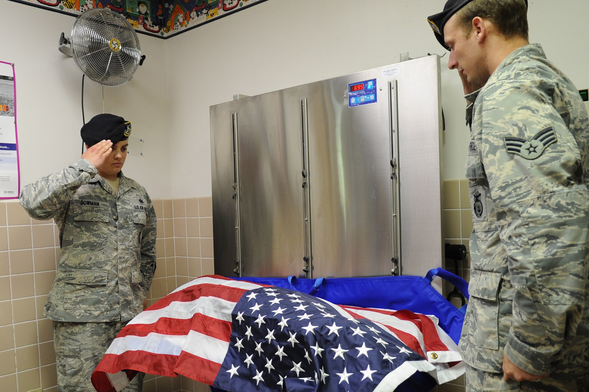 375 Security Forces members render a salute to Military working dog Brix after being put to rest July 18, 2014 at Scott Air Force Base, Ill. Brix's health took a turn for the worse when he started having hip problems. Brix was awarded a Navy Marine Corp Achievement medal and an Army Commendation medal while being deployed in Iraq. He retired in 2011 upon returning from a deployment. (U.S Air Force photo/ Senior Airman Tristin English)
