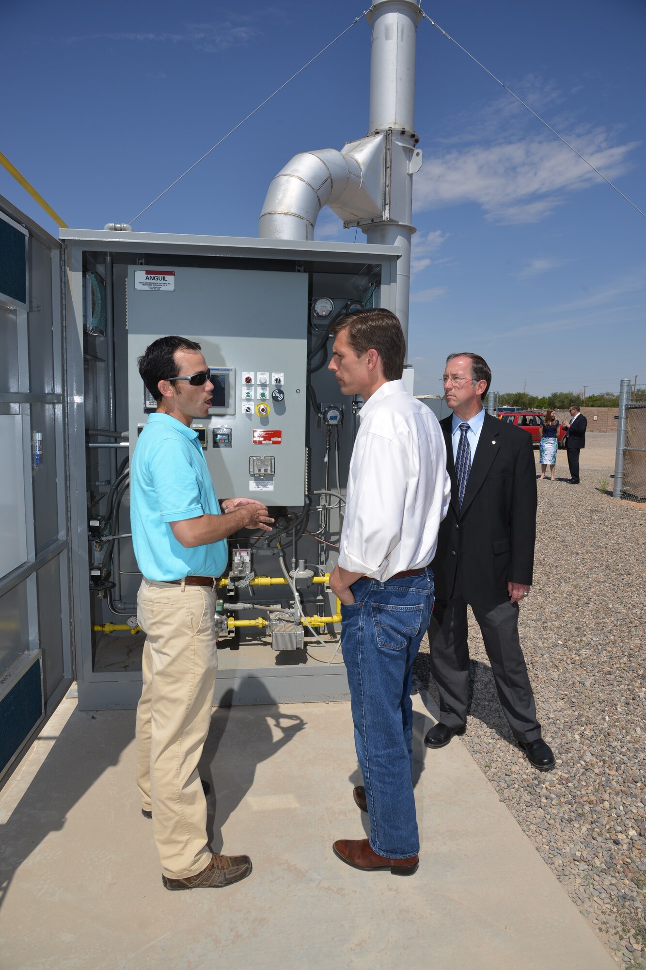 U.S. Senator Martin Heinrich, center, tours the soil vapor extraction site on Kirtland  with David Aubrey (left), CB&I Federal Services scientific technician, and Brent Wilson, base civil engineer, July 19. Senator Heinrich also toured the air sparge site and received information on the base's fuel spill remediation efforts to ensure Albuquerque's drinking water remains safe. (Photo by Ken Moore)