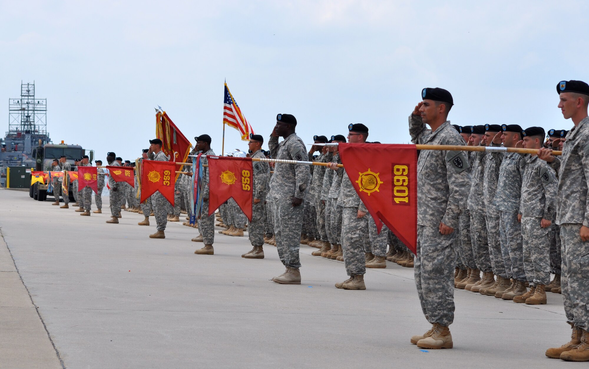 U.S. Army Soldiers from the 10th Transportation Battalion, 7th Transportation Brigade (Expeditionary), stand in formation as they salute the commander of troops during a change of command ceremony held at 3rd Port on Fort Eustis, Va., July 15, 2014.   The 10th Trans. Bn. was constituted July 6, 1942, as Headquarters and Headquarters Company, 10th Port of Embarkation, and re-designated November 30, 1971.  (U.S. Army photo by Sgt. Stefanie Warner/Released)