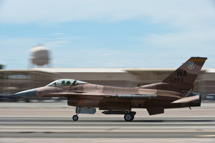 An F-16C Fighting Falcon from the 64th Aggressor Squadron lands after a training mission during Red Flag 14-3, July 15, 2014, at Nellis Air Force Base, Nev. All four branches of the U.S. military and air forces from allied nations participate in Red Flag. This is done to familiarize forces that may have to work together in future operations with each other’s mission capabilities. (U.S. Air Force photo by Airman 1st Class Thomas Spangler)