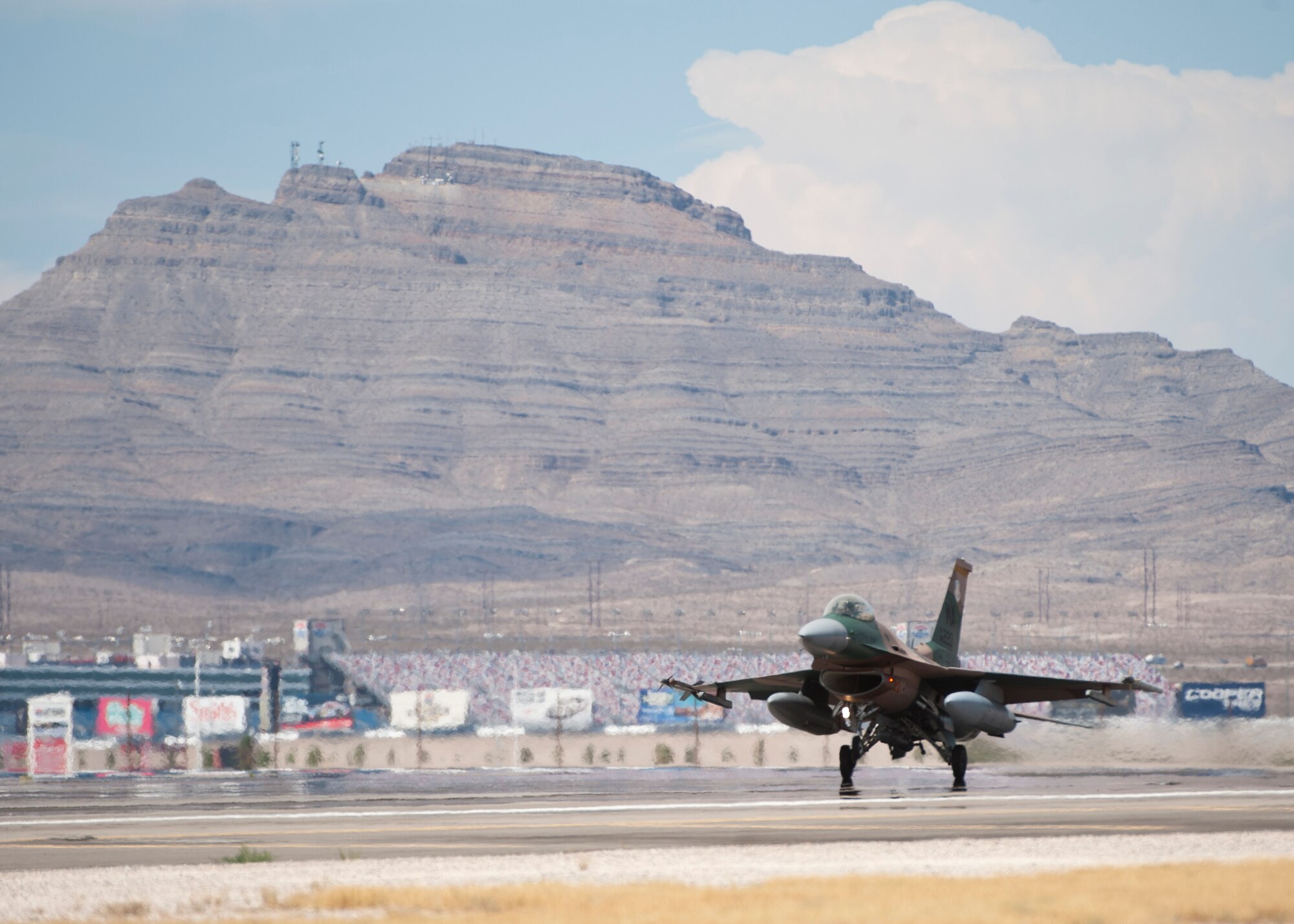 An F-16C Fighting Falcon from the 64th Aggressor Squadron lands after a training mission during Red Flag 14-3, July 15, 2014, at Nellis Air Force Base, Nev. The Aggressors are specially trained to replicate the tactics and techniques used by potential adversaries. Training against simulated adversaries better prepares U.S. and allied forces for potential future conflicts. (U.S. Air Force photo by Airman 1st Class Thomas Spangler)