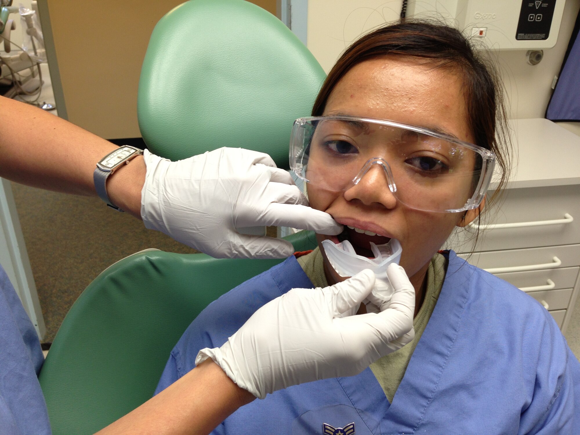 Captain (Dr.) Melissa Holt, 779th Medical Group Dentist fits a mouth guard for Airmen Maria Bettina Inocencion. Mouth guards help to protect teeth from sports injuries.  Military beneficiaries may pick up a mouth guard, free of charge, at the Joint Base Andrews West Fitness Center or at the 779th Dental Clinic, 1601 California Avenue, on Joint Base Andrews. Appointments are not necessary, simply walk-in and request a mouth guard at the front desk. (Air Force Photo)