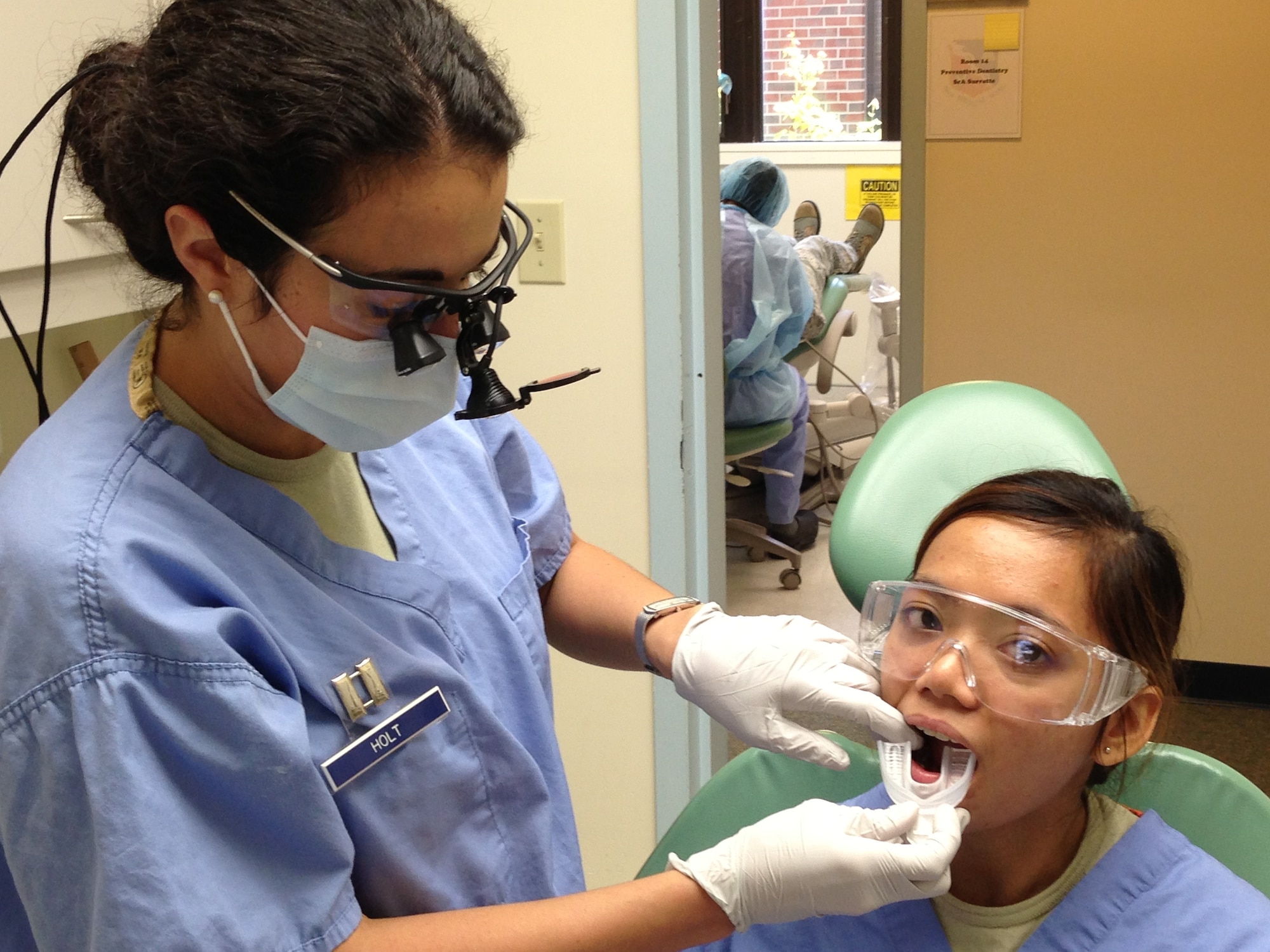 Captain (Dr.) Melissa Holt, 779th Medical Group Dentist fits a mouth guard for Airmen Maria Bettina Inocencion. Mouth guards help to protect teeth from sports injuries.  Military beneficiaries may pick up a mouth guard, free of charge, at the Joint Base Andrews West Fitness Center or at the 779th Dental Clinic, 1601 California Avenue, on Joint Base Andrews. Appointments are not necessary, simply walk-in and request a mouth guard at the front desk. (Air Force Photo)