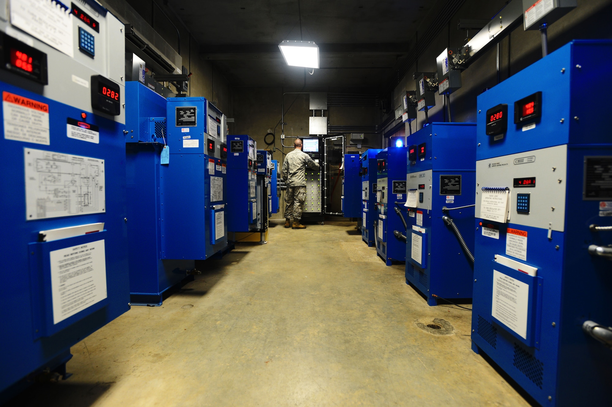 U.S. Air Force Staff Sgt. Nicholes Crumb, 20th Civil Engineer Squadron electrical systems craftsman, activates airfield lights at Shaw Air Force Base, S.C., July 16, 2014. Using a Digitrack lighting system, 19 regulators are used to supply the electrical voltage needed to power the 1,643 airfield runway lights. (U.S. Air Force photo by Airman 1st Class Jensen Stidham/Released)