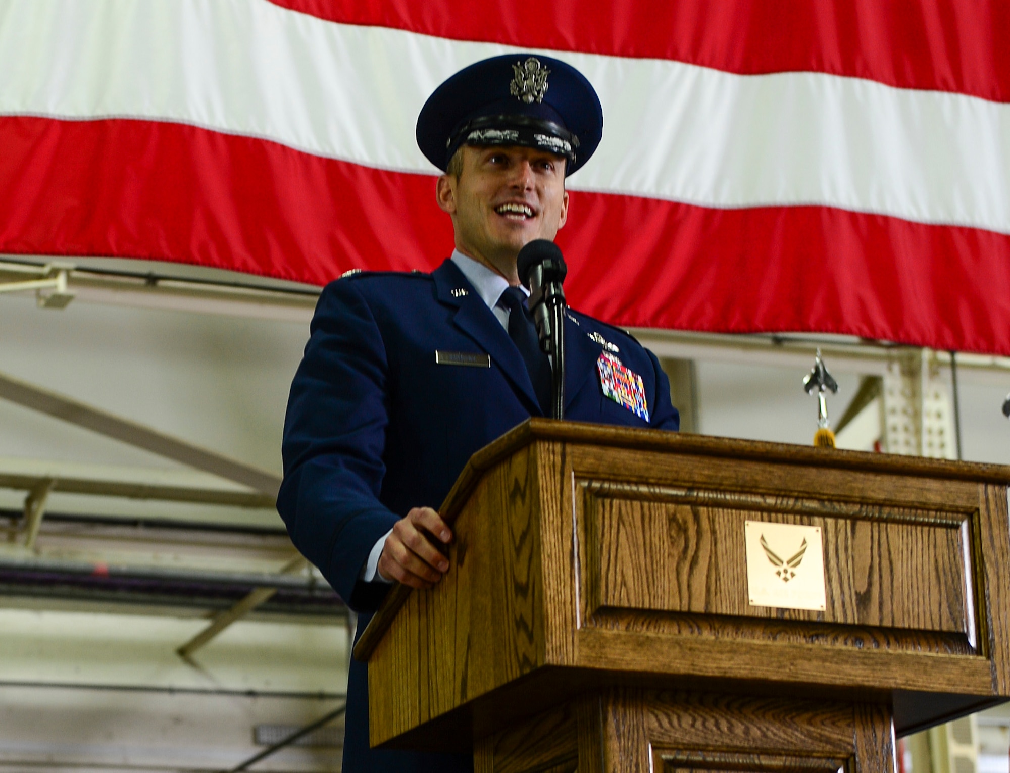 Col. Robert Novotny, 48th Fighter Wing commander, delivers his first speech as commander before approximately 1,000 people during the 48th FW change of command ceremony in Hangar 7 at Royal Air Force Lakenheath, England, July 21, 2014. (U.S. Air Force photo by Airman 1st Class Dawn M. Weber/Released)