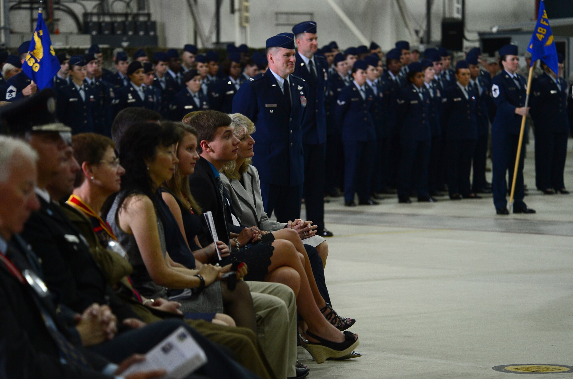Airmen, dignitaries and distinguished visitors from the local area watch as Col. Kyle Robinson relinquishes command of the 48th Fighter Wing to Col. Robert Novotny in Hangar 7 at Royal Air Force Lakenheath, England, July 21, 2014. (U.S. Air Force photo by Airman 1st Class Dana J. Butler/Released)