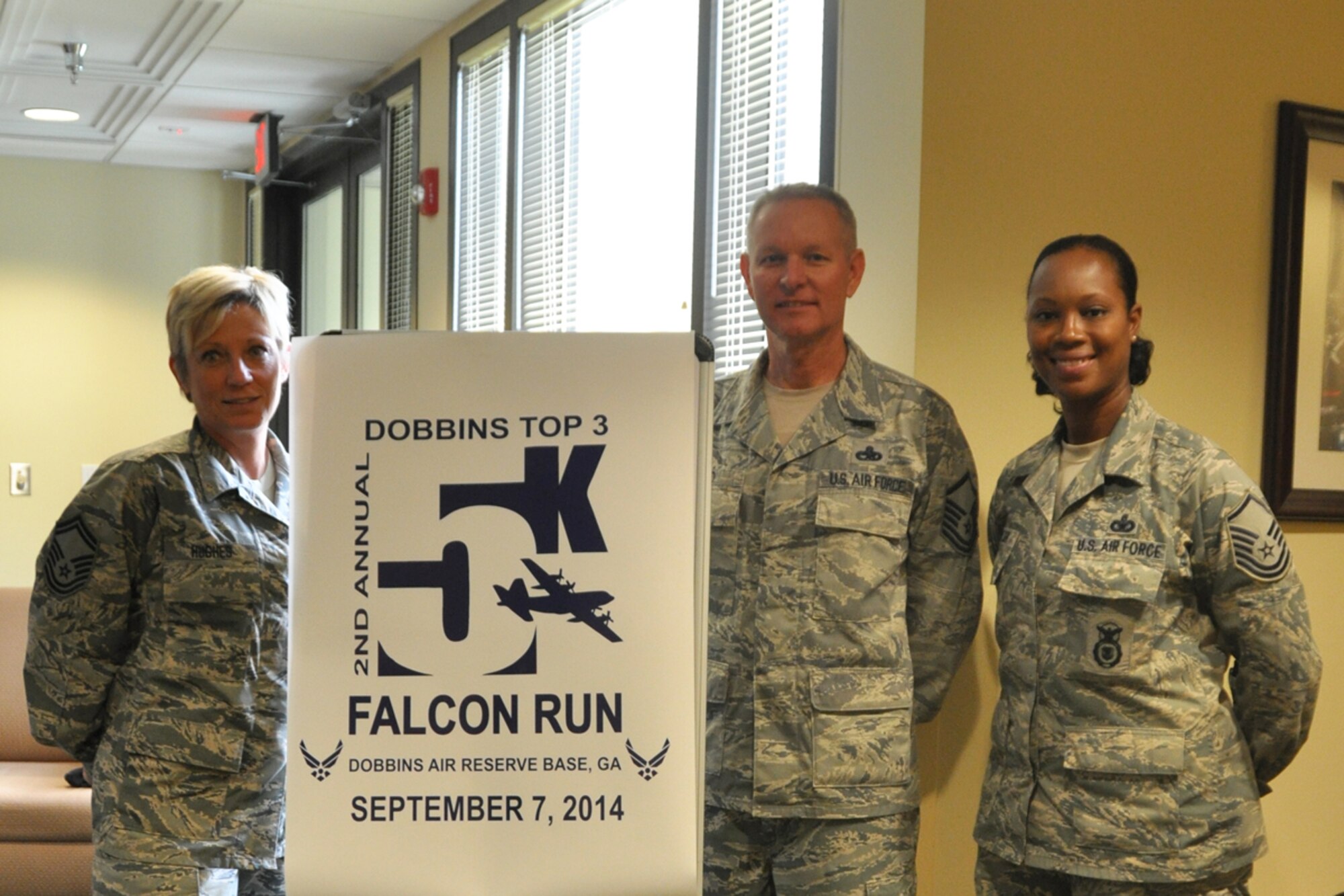 Dobbins Top 3 members Senior Master Sgt. Joy Hughes, Master Sgt. Carl Mayo, and Master Sgt. Engle Coulter register participants for the second annual Falcon 5K at the Dobbins Consolidated Club July 12, 2014. Proceeds from the event go to the Dobbins Emergency Fund used for assisting Airmen in times of need. (U.S. Air Force photo/Master Sgt. James Branch)