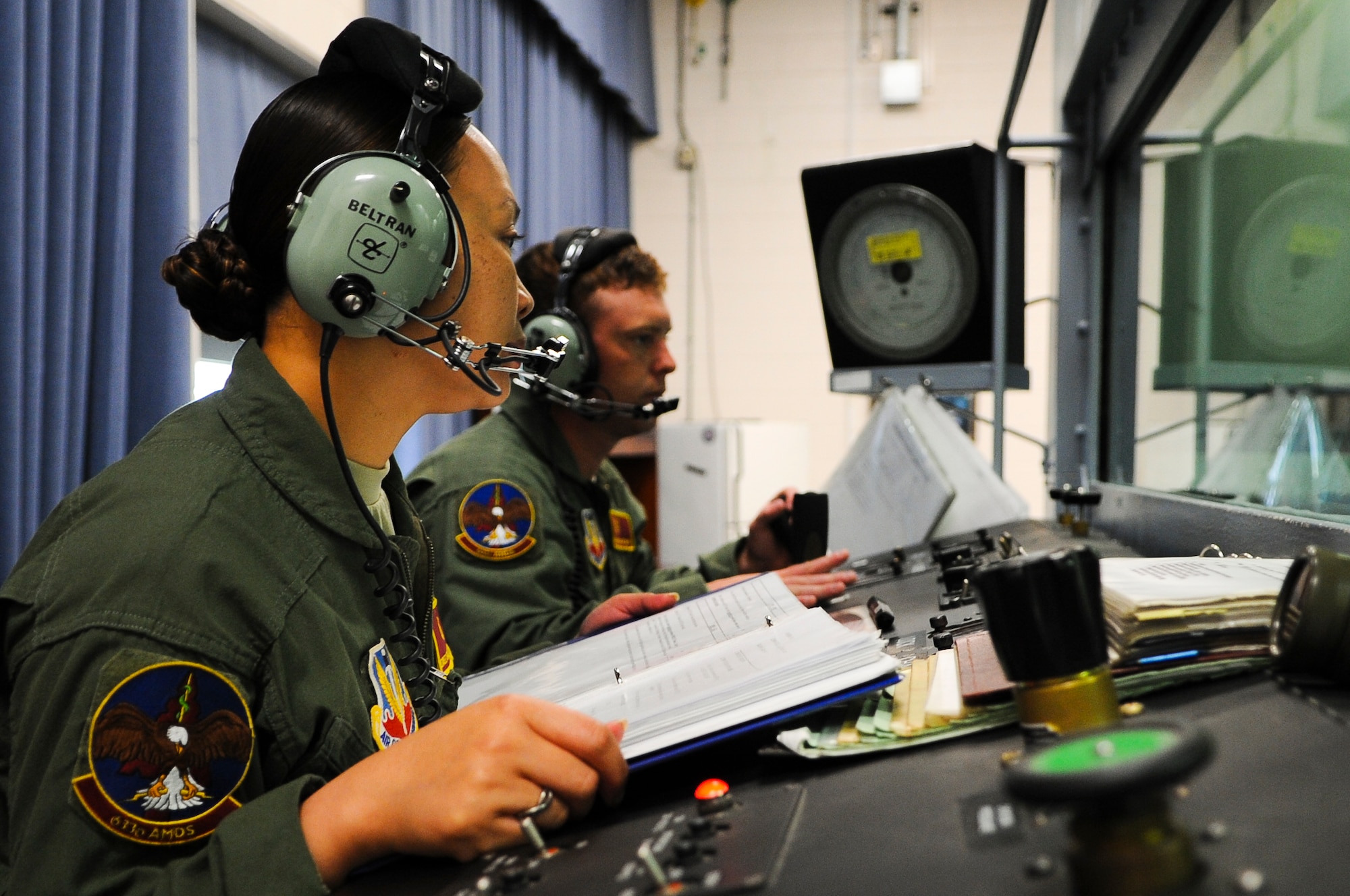 U.S. Air Force Tech. Sgt. Desiree Beltran and Senior Airman Mason Wyman, both 633rd Aerospace Medical Squadron altitude chamber personnel, set up the altitude chamber for a training session at Langley Air Force Base, Va., June 25, 2014. Altitude chamber personnel ensure the chamber participants remain safe as they undergo the effects of hypoxia for training purposes. (U.S. Air Force photo by Senior Airman Austin Harvill/Released)
