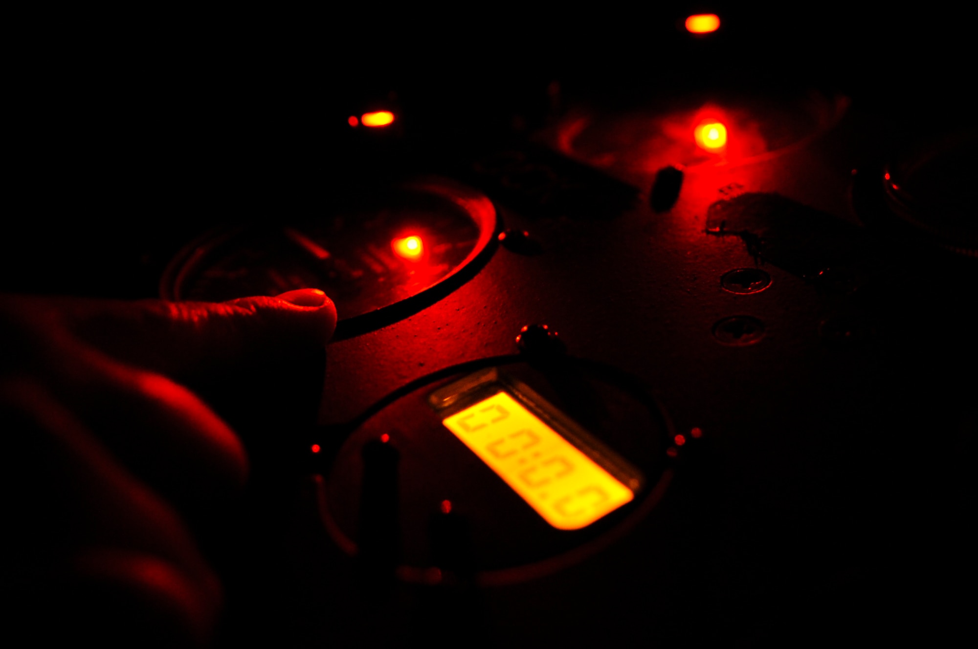 U.S. Air Force Senior Airman Mason Wyman, 633rd Aerospace Medical Squadron aerospace physiology technician, reads gauges during altitude chamber training session at Langley Air Force Base, Va., June 25, 2014. Personnel turn off all lights in the altitude chamber to simulate night-time operations at high altitudes. (U.S. Air Force photo by Senior Airman Austin Harvill/Released)