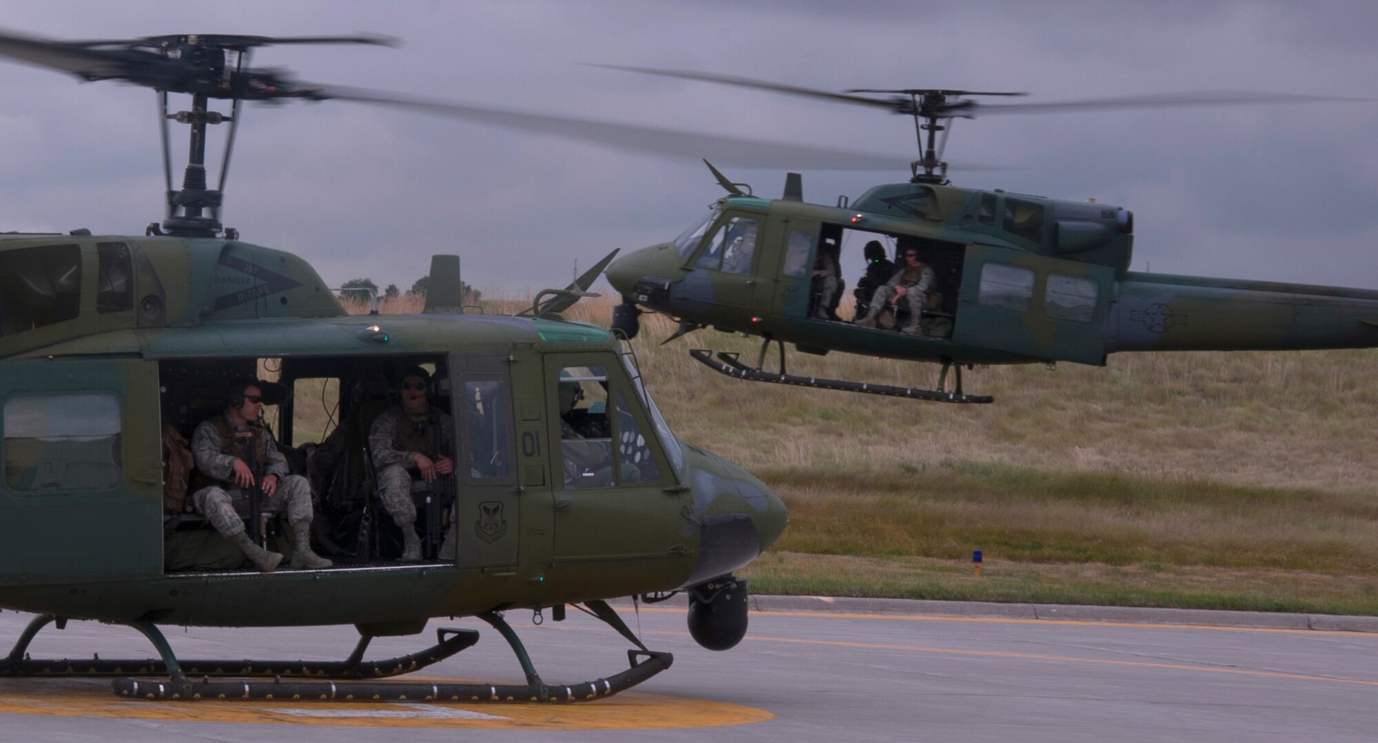 Helicopters full of 90th Security Forces Group Tactical Response Force Airmen take off July 16 from the 37th Helicopter Squadron to perform convoy escort duties. The 37th HS and the 90th SFG TRF routinely train together to execute missions in the field. (U.S. Air Force photo by Airman 1st Class Brandon Valle)