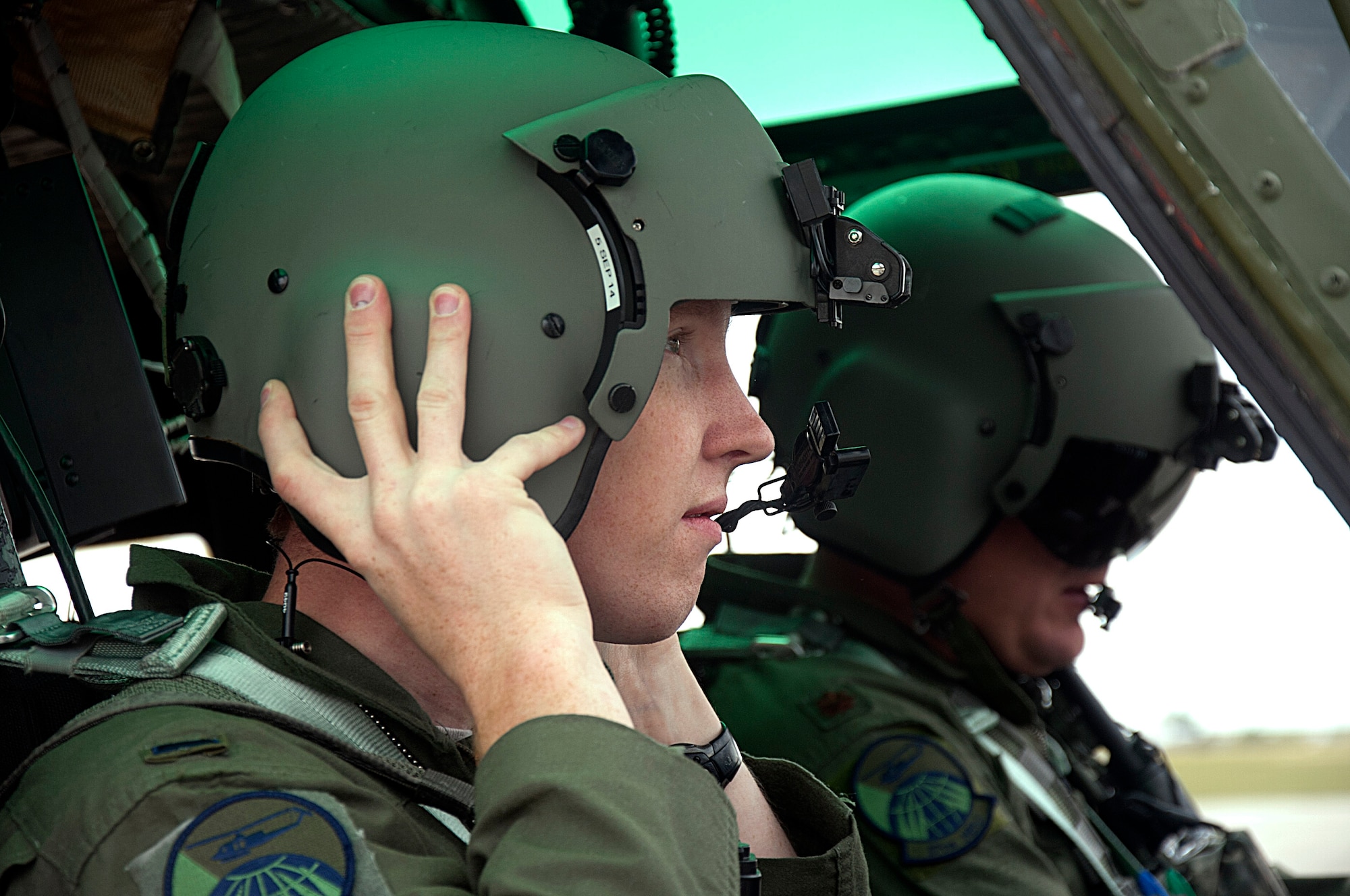 1st Lt. Carter Vanworth, 37th Helicopter Squadron, places his helmet on before taking off July 16. Each helmet is equipped with a head set for communication between each member of the crew as well as back at base. (U.S. Air Force photo by Airman 1st Class Brandon Valle) 