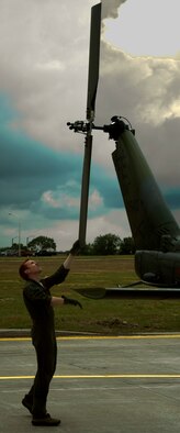 1st Lt. Carter Vanworth, 37th Helicopter Squadron, checks the rear rotor-blades July 16 during the pre-flight check. Vanworth performed the role of co-pilot in a four-man crew training mission. (U.S. Air Force photo by Airman 1st Class Brandon Valle)