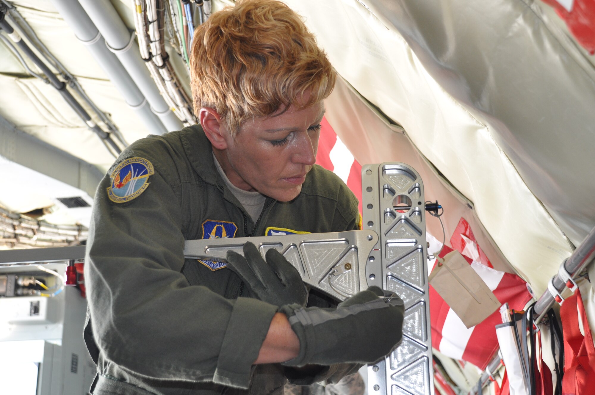 Tech. Sgt. Maria Ayala assembles a portable litter stanchion for transporting patients during a quarterly training mission July 18th. The KC-135 Stratotanker is one of several aircraft the 45th AES is able to convert into a mobile hospital to provide care to patients while transporting them to medical facilities in Germany and the U.S. (U.S. Air Force photo by Capt Joe Simms)