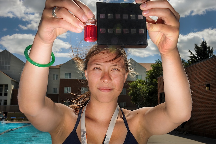 Chloe Rickards, Outdoor Recreation lifeguard, checks chemical levels in a sample of pool water against a scale at the outdoor pool on Minot Air Force Base, N.D., July 13, 2014. Frequent tests are performed daily, on both the adult and children’s pools, to ensure the safety and sanitation of the water. (U.S. Air Force photo/Senior Airman Stephanie Morris)