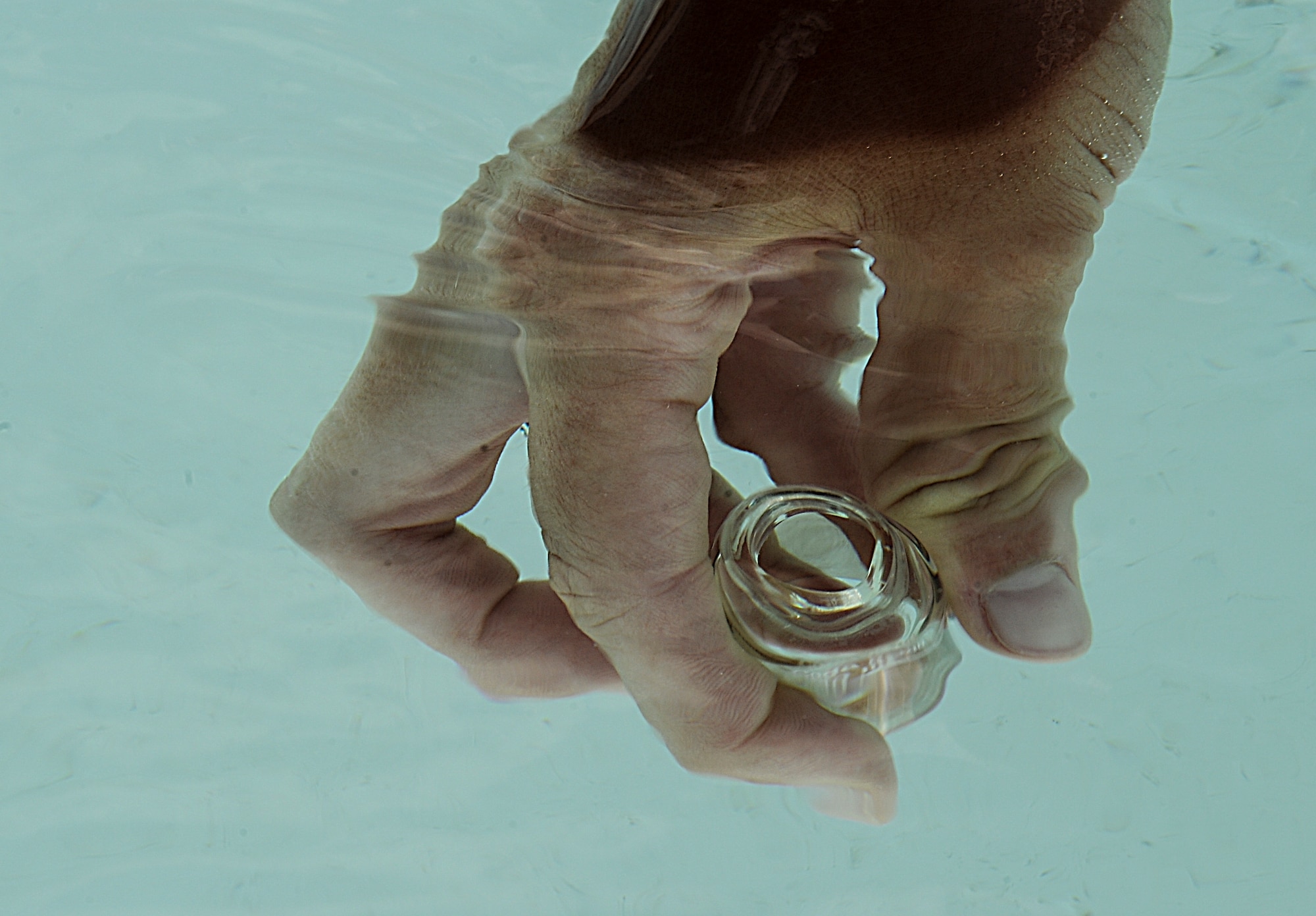 Water samples are collected at the outdoor pool on Minot Air Force Base, N.D., July 13, 2014. The pool water is sampled every hour to ensure proper chemical levels and sanitation. (U.S. Air Force photo/Senior Airman Stephanie Morris)