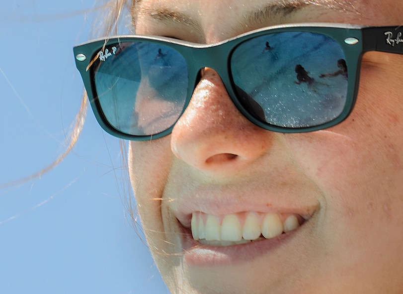 Chloe Rickards, Outdoor Recreation lifeguard, watches over swimming children at the outdoor pool on Minot Air Force Base, N.D., July 13, 2014. Rickards has been a lifeguard at the pool for approximately one year. (U.S. Air Force photo/Senior Airman Stephanie Morris)