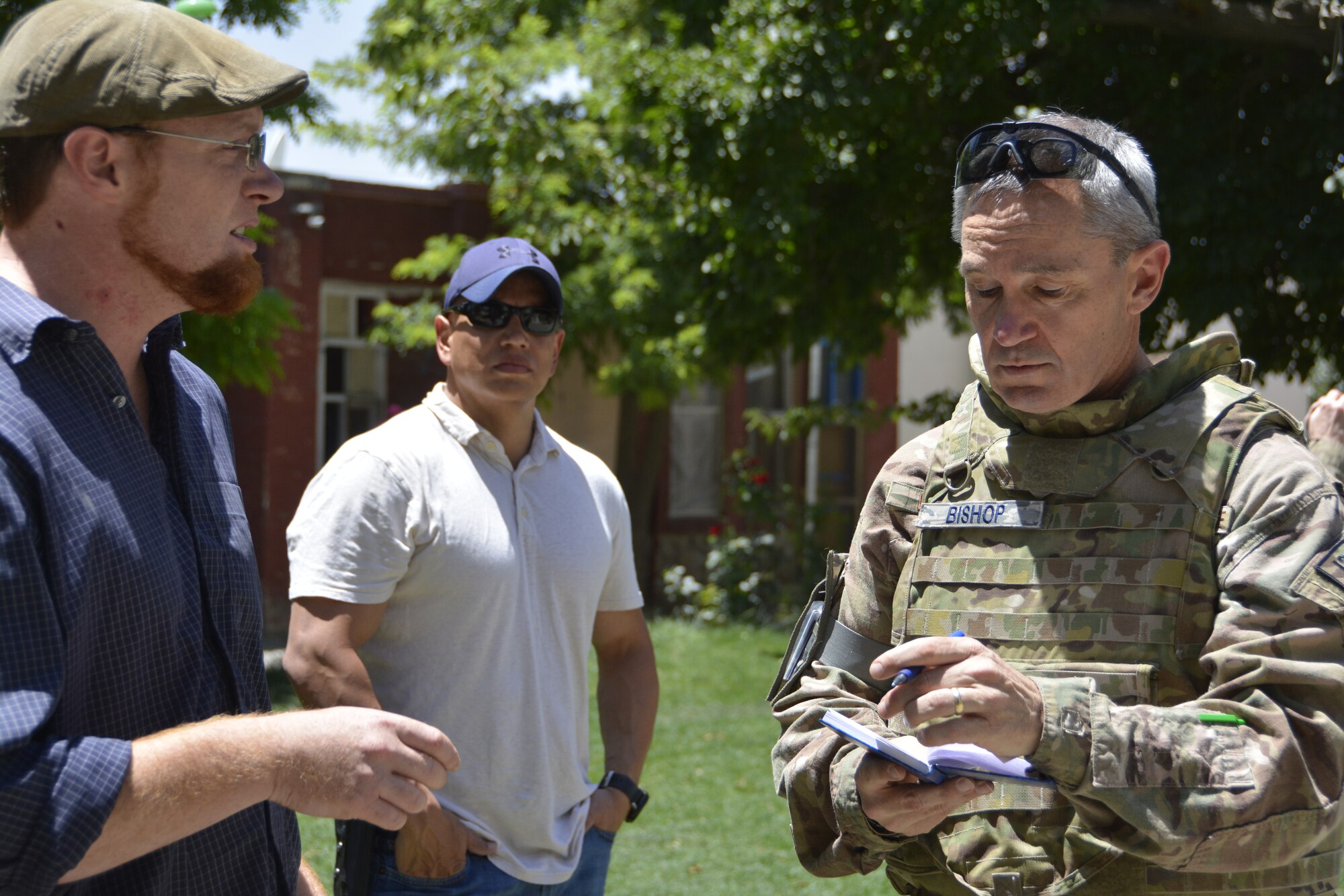 Lt. Col. James Bishop, Westover Reservist, interviews J. Reese Hume, humanitarian group PARSA’s project manager. Bishop, along with 11 members of the International Security Assistance Forces, brought more than 800 pounds of donated clothing, toys, and school supplies to Afghan children at a residential compound near Kabul, Afghanistan July 18. (U.S. Navy photo by LT. Peter Buttigieg, ISAF HQ)