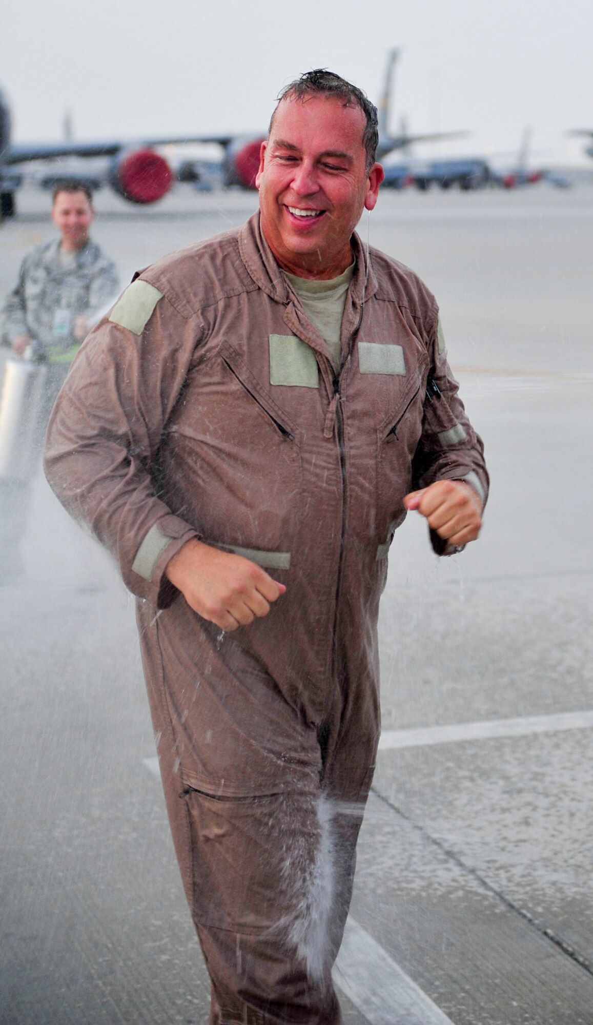 U.S. Air Force Senior Master Sgt. Floyd W. Atkins, 340th Expeditionary Air Refueling Squadron boom opterator, is hosed down after completeing his  air fueling flight. Atkin reached the 8,000 hours mark at the completion of the flight, a boom operator will normally reach  5,000 to 6,000 refueling hours in their career. Adkins homestation is 151st Air Refueling Squadron Tennessee Air National Guard. (U.S. Air Force photo by Senior Airman Colin Cates)