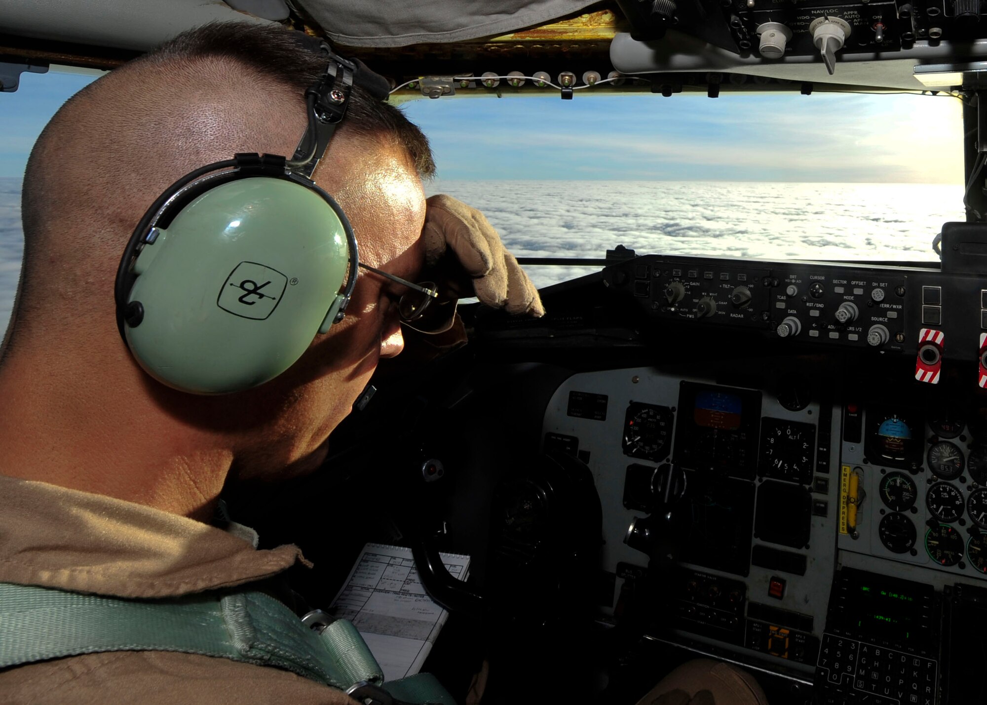 U.S. Air Force Col. James Dittus, 379th Expeditionary Operations Group commander, checks intrustments on a KC-135 Stratotanker during a flight over  Afghanistan July 17, 2014. Stratotankers at the 340th Expeditionary Air Refueling Squadron provide daily aerial refueling support to U.S. and coalition forces. (U.S. Air Force photo by Senior Airman Colin Cates) 