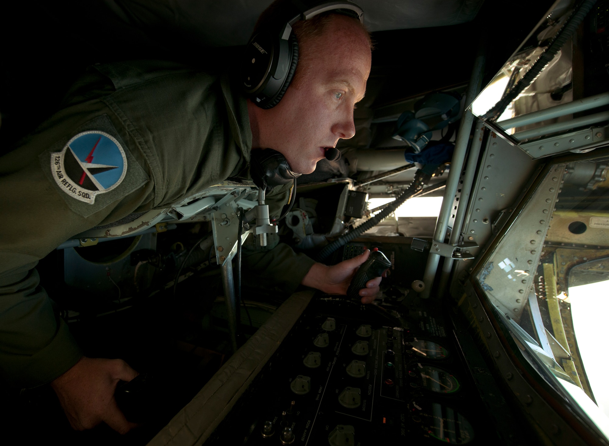 U.S. Air Force Staff Sgt. Brad Love maneuvers the boom of a KC-135R Stratotanker into position to refuel a B-2 Spirit during a refueling mission over the North Atlantic Ocean June 11, 2014. The B-2s are conducting training flights and regional familiarization in the U.S. European Command area of operations.  Love is a boom operator with the 126th Air Refueling Squadron of the Wisconsin Air National Guard. The B-2 is a multi-role bomber capable of delivering both conventional and nuclear munitions. (U.S. Air Force photo by Tech. Sgt. Paul Villanueva II/Released)