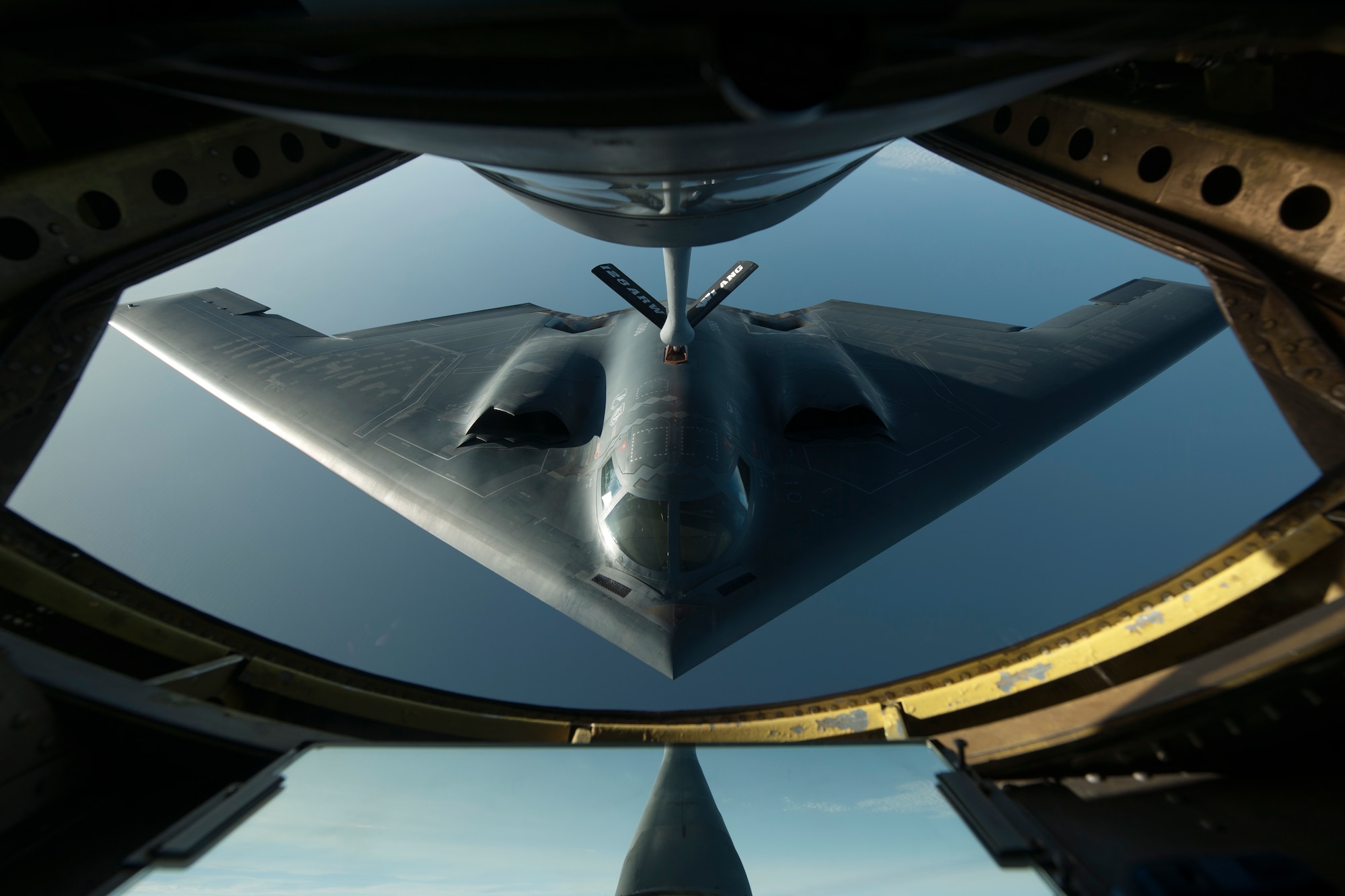 A B-2 Spirit flies into position during a refueling mission over the North Atlantic Ocean June 11, 2014. The B-2 is conducting training flights and regional familiarization in the U.S. European Command area of operations. The B-2 is a multi-role bomber capable of delivering both conventional and nuclear munitions. (U.S. Air Force photo by Tech. Sgt. Paul Villanueva II/Released)