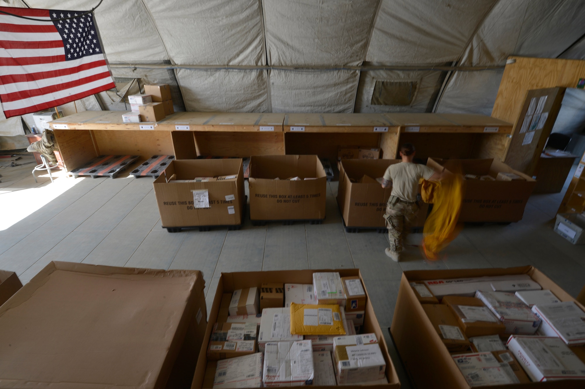 U.S. Air Force Senior Airman Victoria Hill, 455th Expeditionary Communications Squadron mail clerk, sorts through pallets of mail at Bagram Airfield, Afghanistan June 26, 2014.  Hill is responsible for delivering mail to all Airmen in the 455th Expeditionary Wing.  She is deployed from Whiteman Air Force Base and a native of Blanchard, La. (U.S. Air Force photo by Staff Sgt. Evelyn Chavez/Released)
