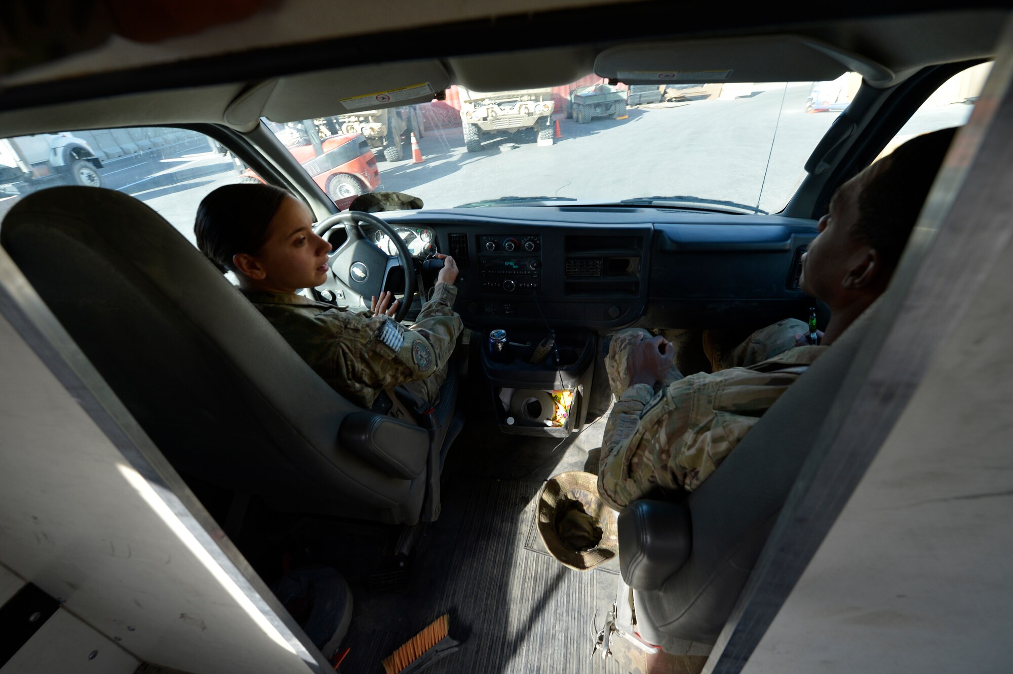 (From left) U.S. Air Force Senior Airmen Victoria Hill and Lorenza Kates, 455th Expeditionary Communications Squadron mail clerks, drive to the centralized mail location to pick mail up at Bagram Airfield, Afghanistan June 26, 2014.  Hill and Kates deliver an average of 77 pallets of mail per week.  Hill is deployed from Whiteman Air Force Base, Mo.  and a native of Blanchard, La. Kates is deployed from Davis Monthan Air Force Base, Ariz. and a native of Dublin, Ga. (U.S. Air Force photo by Staff Sgt. Evelyn Chavez/Released)