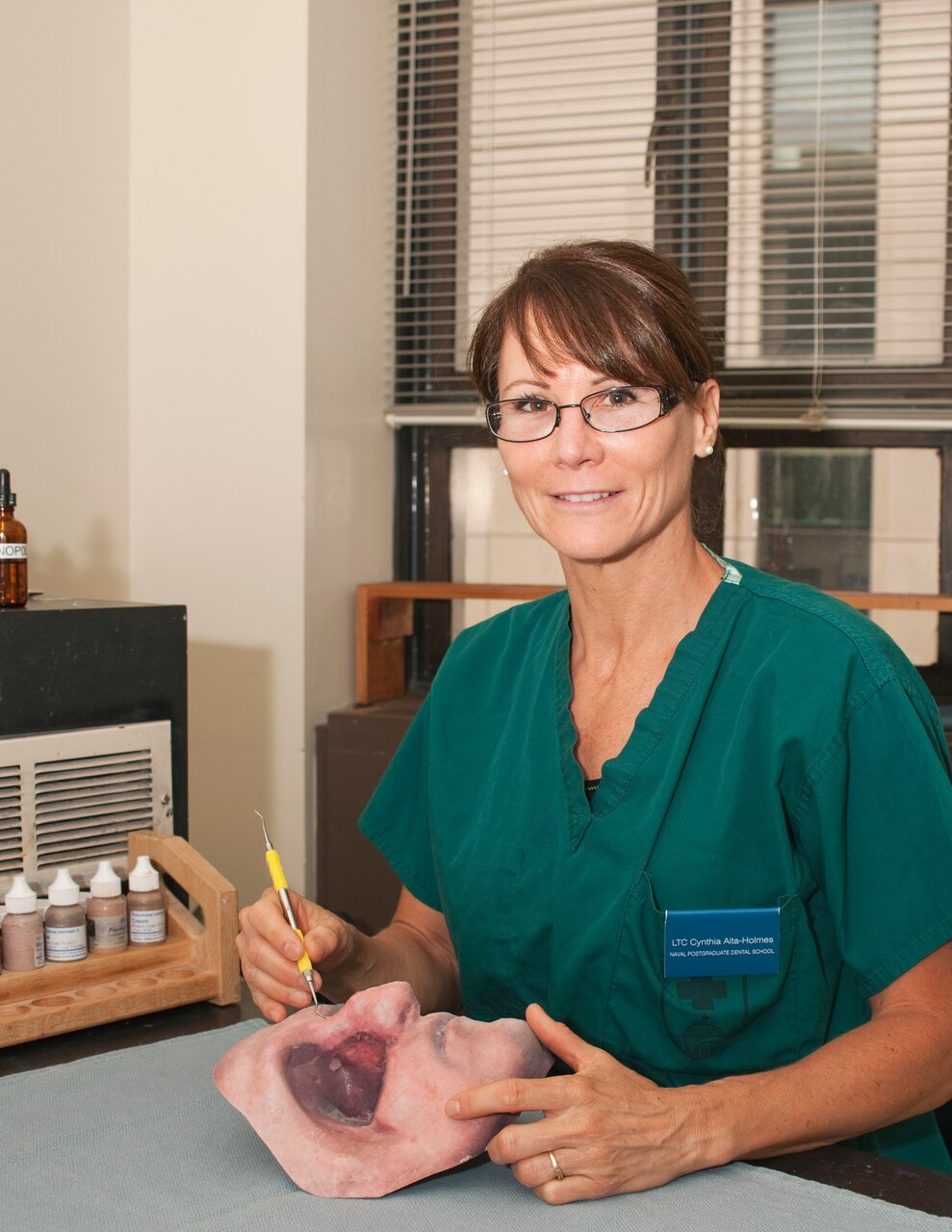 Army Lt. Col. Cynthia Aita-Holmes -- a maxillofacial prosthodontist who earned her master’s degree from the Postgraduate Dental College at the Uniformed Services University of the Health Sciences in Bethesda, Md. -- creates synthetic body parts from molds cast into silicone that are painted to match the unique characteristics of a person’s face. In best-case scenarios, the transition from skin to silicone is nearly indiscernible. DoD photo by Thomas C. Balfour