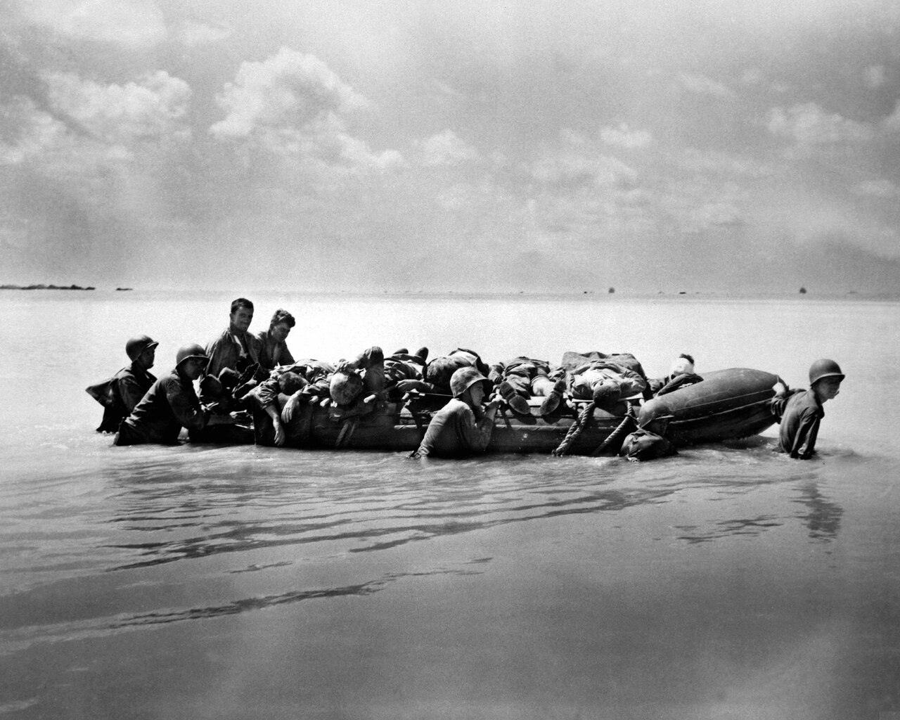 Marines wounded during the landing on Tarawa in November 1943 are towed out on rubber boats to larger vessels that will take them to base hospitals. Marine Corps photo