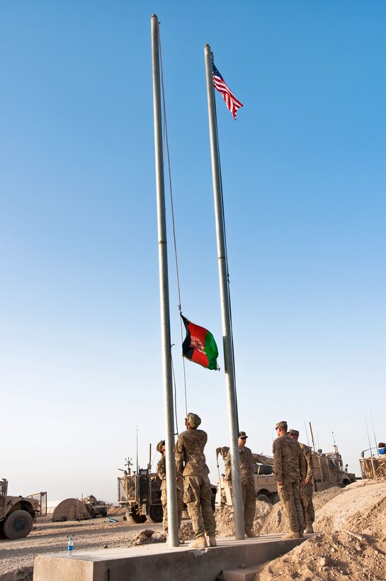 From left to right, U.S. Army Spc. Jamie Morris, U.S. Army Spc. Daniel Adensam, U.S. Army Command Sgt. Maj. Kevin King, U.S. Army Spc. Ricky Schumann and U.S. Army Spc. William Banks lower the Afghan flag during base closure operations on Forward Operating Base Walton in Afghanistan's Kandahar province, July 15, 2014. Morris, Adensam, King, Schumann and Banks are assigned to the 4th Infantry Division's 4th Infantry Brigade Combat Team.