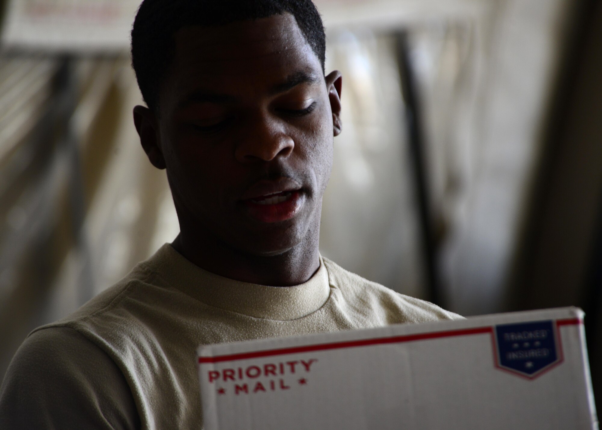 U.S. Air Force Senior Airman Lorenza Kates, 455th Expeditionary Communications Squadron mail clerk, sorts mail at Bagram Airfield, Afghanistan June 26, 2014.  Kates is responsible for delivering mail to all Airmen assigned to the 455th Expeditionary Wing.  Kates is deployed from Davis Monthan Air Force Base, Ariz. and a native of Dublin, Ga. (U.S. Air Force photo by Staff Sgt. Evelyn Chavez/Released)