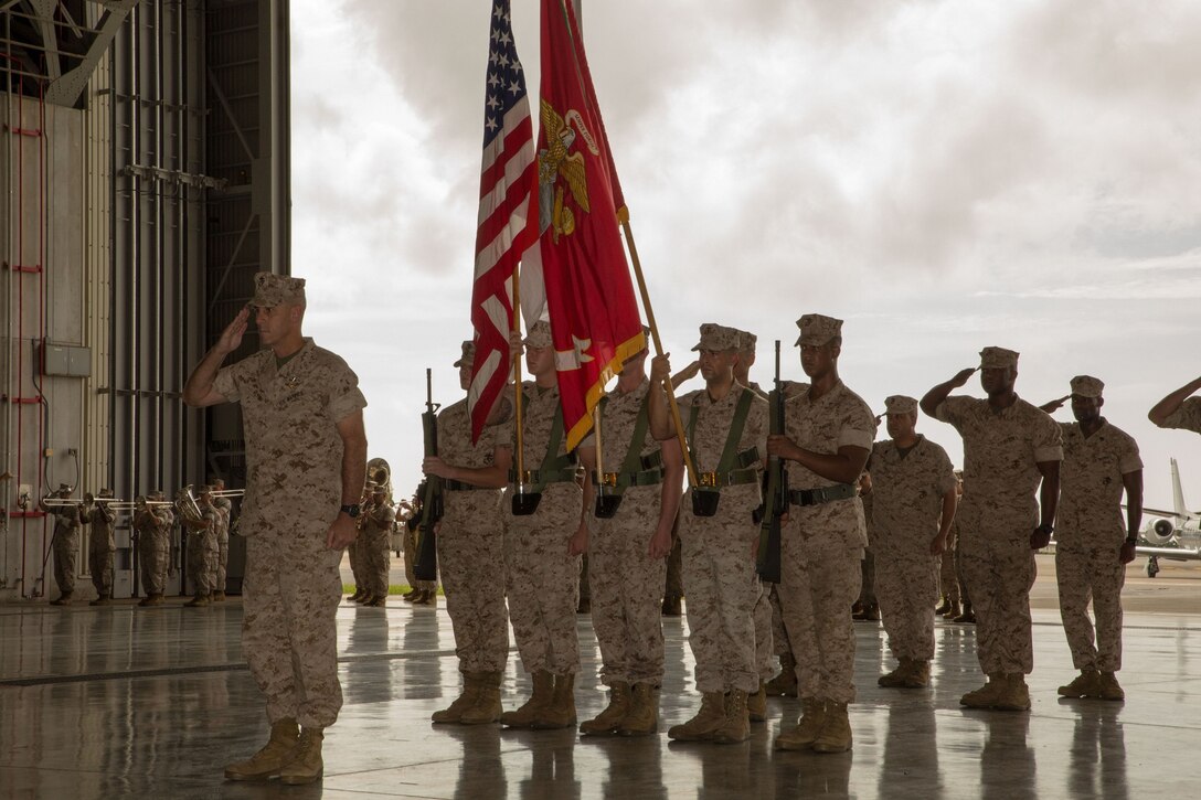 Col. James G. Flynn, left, renders a salute July 11 at Marine Corps Air Station Futenma during his retirement ceremony. Flynn celebrated his retirement after 25 years of service to the Marine Corps following the transfers of his duties as commanding officer of MCAS Futenma to Col. Peter N. Lee. Flynn served as the commanding officer of MCAS Futenma from 2011 to 2014. (Marine Corps Photo by Cpl. Natalie M. Rostran/ Released)