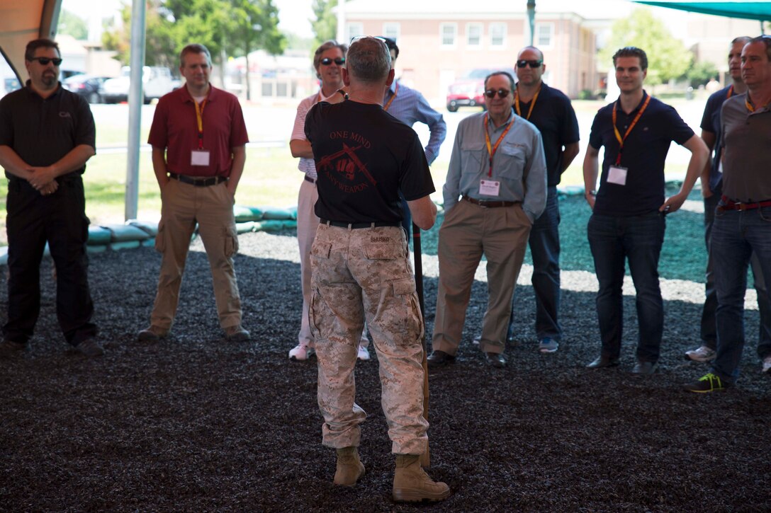 Retired Lt. Col. Joseph Shusko, director of the Marine Corps Martial Arts Center of Excellence, explains MCMAP techniques and philosophy to the participants of the Marine Corps Executive Forum on July 18, 2014. Seventeen civilian leaders attended the forum, learning about various aspects of the Marine Corps.