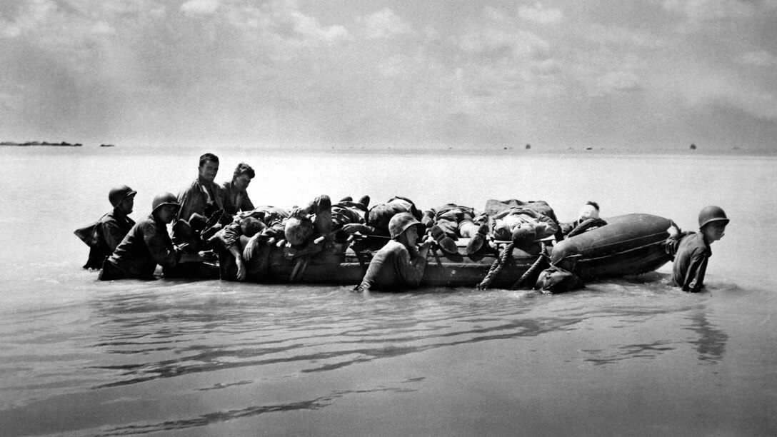 Marines wounded during the landing on Tarawa are towed out on rubber boats by their buddies to larger vessels that will take them to base hospitals for better medical care.  November 1943. (Marine Corps)
Exact Date Shot Unknown
NARA FILE #:  127-G-63454
WAR & CONFLICT #:  913