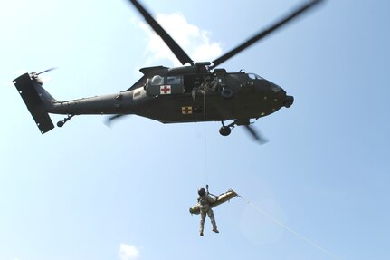 Sgt. Natsuki Hama, a Georgia Guard member with Detachment 1, Charlie Company, 1-111th General Support Aviation Battalion, is hoisted by Sgt. Chad Evans into a UH-60M Blackhawk helicopter in Marietta, Georgia, July 13, 2014, as part of a hoist-training exercise.