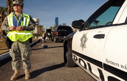 Nevada Army National Guard Spc. Ashlee Wolf stands guard on New
Year's Eve here for Vigilant Sentinel, a three-day training exercise where Nevada Guard members work in association with Las Vegas Metro Police.