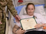 Oklahoma Army National Guard Spc. Ashley Jones receives the Purple Heart from Army Brig. Gen. Gary Volesky, deputy commanding general for maneuver with Combined Joint Task Force-1, at Craig Joint Theatre Hospital on Bagram Airfield, Afghanistan, on Dec. 19, 2011, for injuries sustained as a result of an improvised explosive device the previous day.