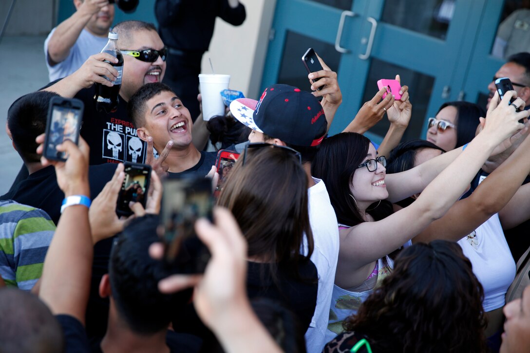 Comedian Gabriel Iglesias takes selfies with fans at a sneak preview of his new movie “Fluffy” at the Bulldog Box Office on Camp Pendleton July 18. The movie was free to the first 1,300 people in line. 
