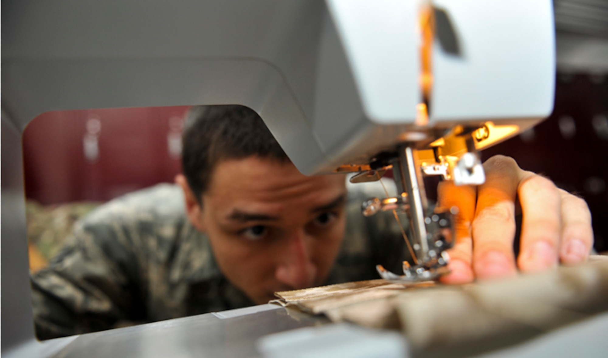 Senior Airman Devin Litton uses a sewing machine, July 18, 2014, at McConnell Air Force Base, Kan. Sewing is one of several skills an aircrew flight equipment Airmen must master to repair life rafts and other emergency tools. Litton is a 22nd Operations Support Squadron aircrew flight equipment journeyman. (U.S. Air Force photo/Airman 1st Class John Linzmeier) 